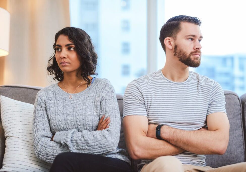 Cropped shot of a young couple giving each other the silent treatment during a fight at home